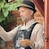 A wine tasting guide wearing an alpine hat and holding a glass of wine